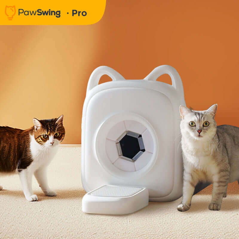 Two cats beside the PawSwing AutoComb Pro, a white automatic grooming tool for cats.