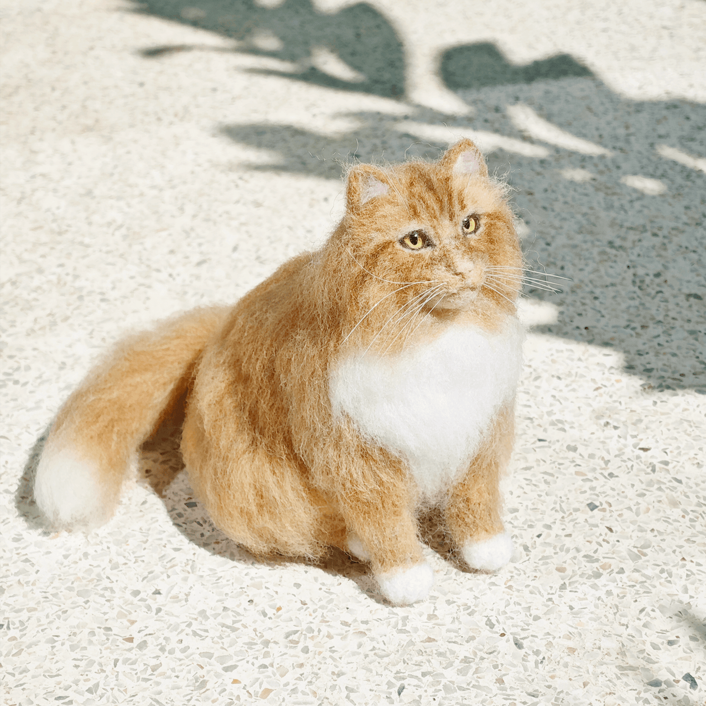 A studio shot of a PawSwing® custom cat doll highlighting the craftsmanship involved in every detail