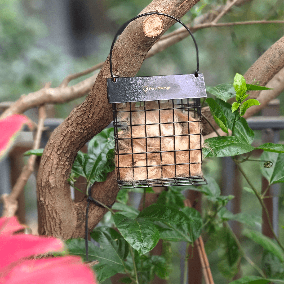Close-up of a PawSwing® cat hair suet cage, providing natural insulation materials for garden birds