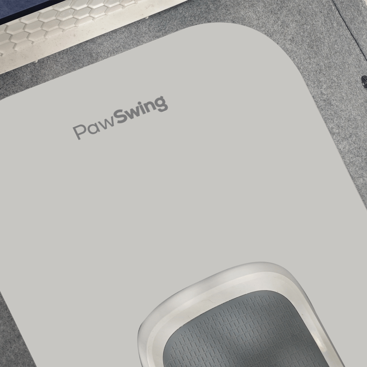 Detail of the non-slip PawSwing® cat box mat highlighting its precision-cut shape and logo