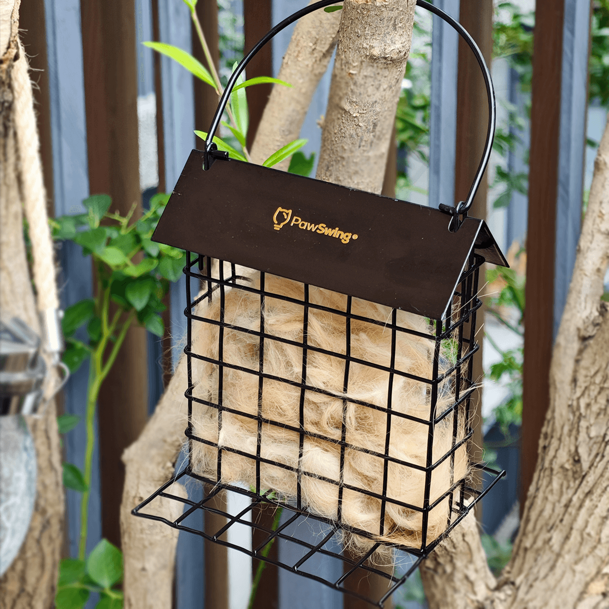 A PawSwing® cat hair cage filled with soft fibers, helping birds create warm and cozy nests