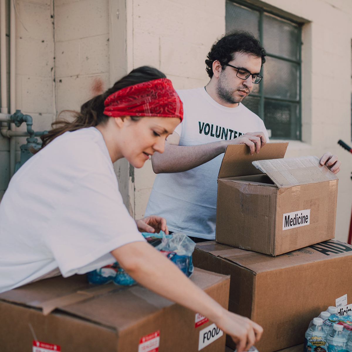 Volunteers pack essential supplies, reflecting PawSwing®'s commitment to pet welfare beyond just selling high-quality cat grooming tools.