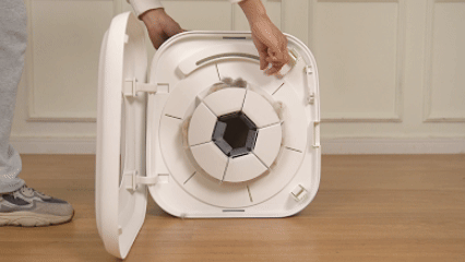 Demonstrating the easy-to-clean internal mechanism of the PawSwing® neo grooming brush for cat